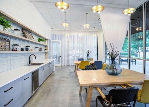 A modern kitchen with a dining table and chairs.