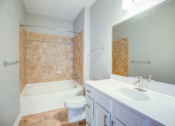 A bathroom with a toilet, sink, and shower.