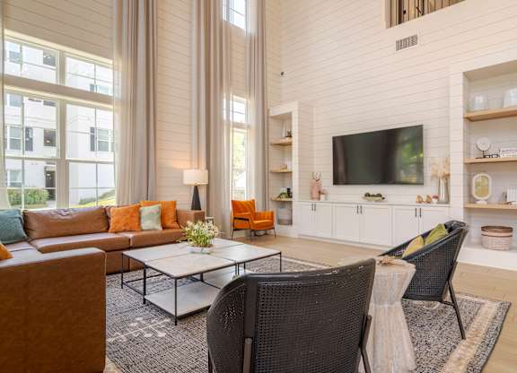 A living room with a brown chair and a white couch.