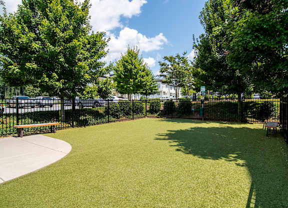 A park with a green lawn and trees.