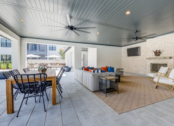 a living room with a couch and a table and a fireplace at Residences at 393 North Apartments, Florida