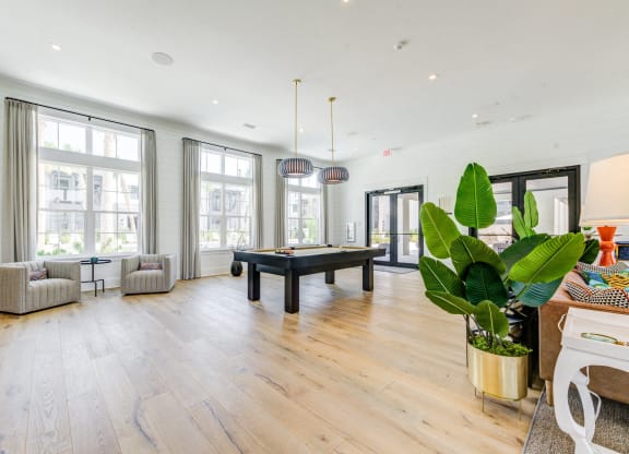 a living room with a pool table in the center of it at Residences at 393 North Apartments, Santa Rosa Beach, FL, 32459