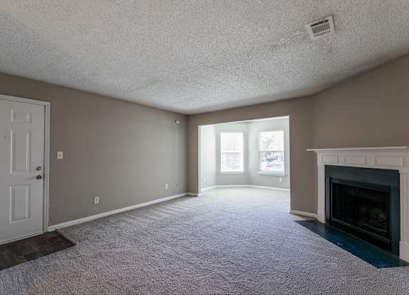 A room with a fireplace and a door.