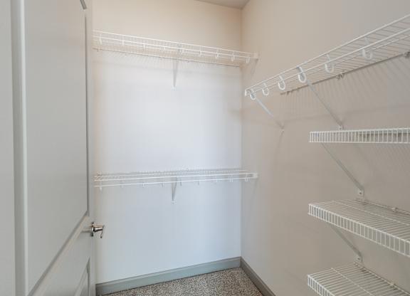 A white refrigerator with empty shelves and a door open.