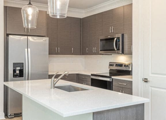 a kitchen with a sink and a refrigerator at Residences at 393 North Apartments, Santa Rosa Beach