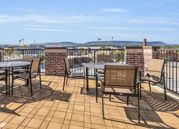 a patio with tables and chairs on a balcony at 17 Broad, Tennessee, 37408