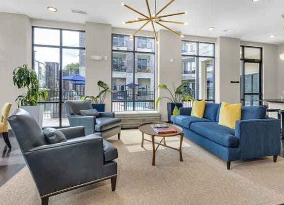 a living room with couches chairs and a table at 17 Broad, Chattanooga Tennessee