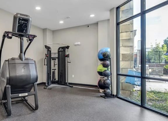 a home gym with exercise equipment and a window at 17 Broad, Chattanooga