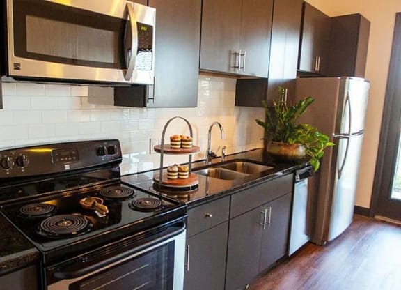 a kitchen with a spiral staircase and stainless steel walls at 17 Broad, Chattanooga, 37408