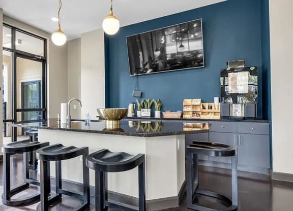 a kitchen with a bar and stools at 17 Broad, Tennessee