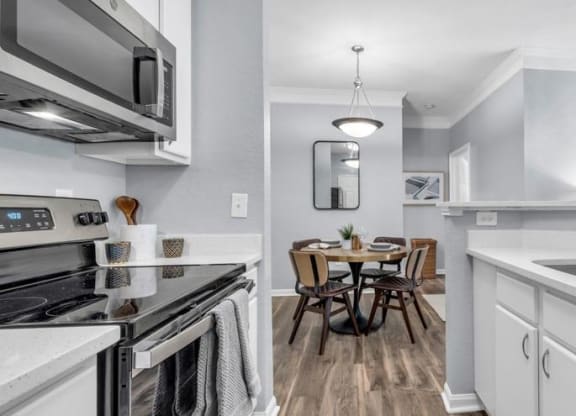 a kitchen with a sink and a stove and a table at Marina Point, Chattanooga