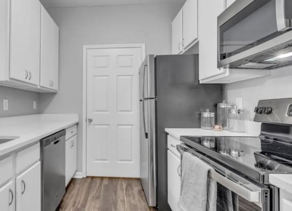a kitchen with stainless steel appliances and white cabinets at Marina Point, Tennessee