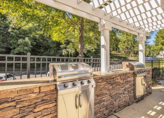a patio with a barbecue grill and a stone wall at Marina Point, Chattanooga, 37415