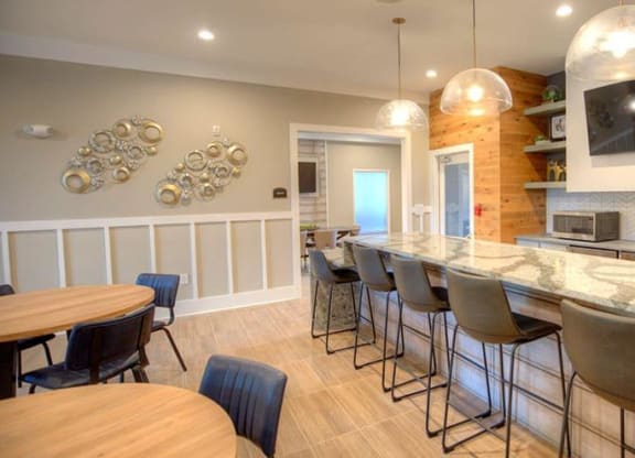 a kitchen with a bar and a table with chairs  at Lullwater at Big Ridge, Hixson, TN, 37343