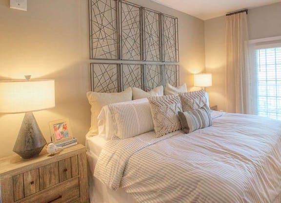 a bedroom with a large bed and a window  at Lullwater at Big Ridge, Hixson