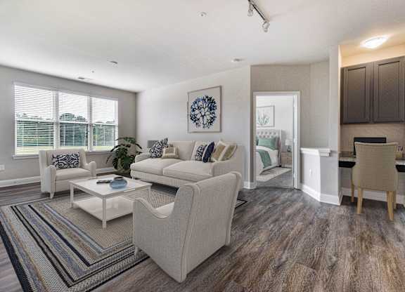 A living room with a white couch and a coffee table.
