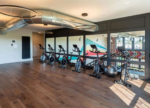 a room with exercise bikes in it at Livingston Flats Apartments, Chesterfield, VA
