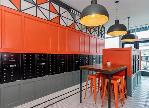 a table and chairs in a room with orange cabinets at Livingston Flats Apartments, Chesterfield