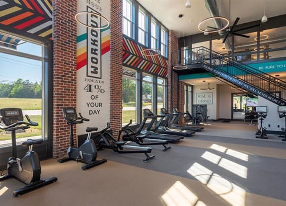 a gym with treadmills and other exercise equipment at  Livingston Flats Apartments, Virginia