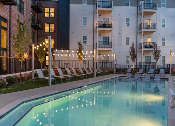 an apartment complex with a pool and lounge chairs at Livingston Flats Apartments, Chesterfield, ,23832