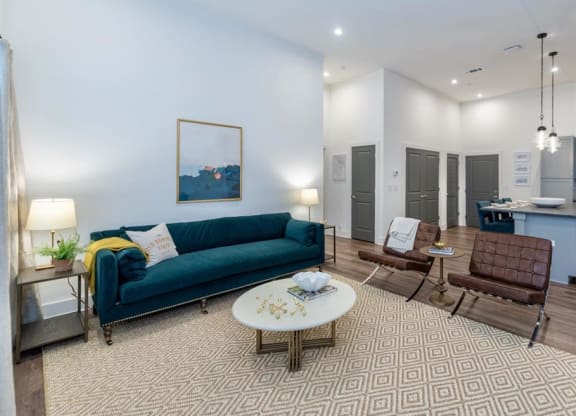 a living room with a blue couch and two chairs at Livingston Flats Apartments, Chesterfield, VA, 23832