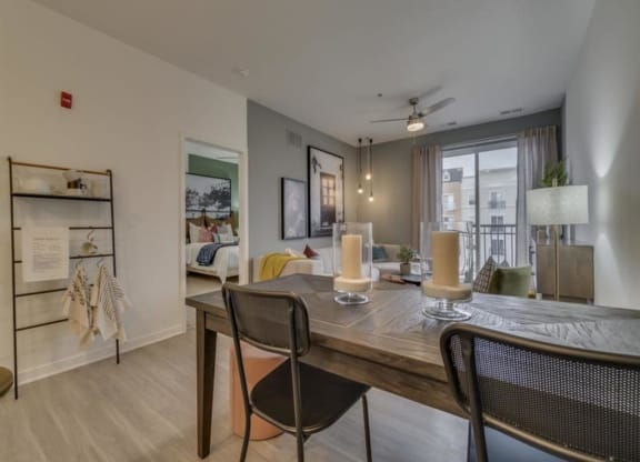 a dining area with a table and chairs and a couch in the background at Flats at West Broad Village, Glen Allen, VA 23060