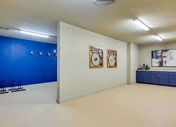 a room with a blue wall and two clocks on the wall at Artistry at Winterfield Apartments, Midlothian ,23112