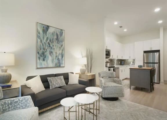 a living room with a couch and two chairs at Artistry at Winterfield Apartments, Midlothian