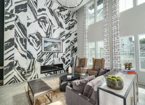 a living room with a large couch and a fireplace at Artistry at Winterfield Apartments, Midlothian ,23112
