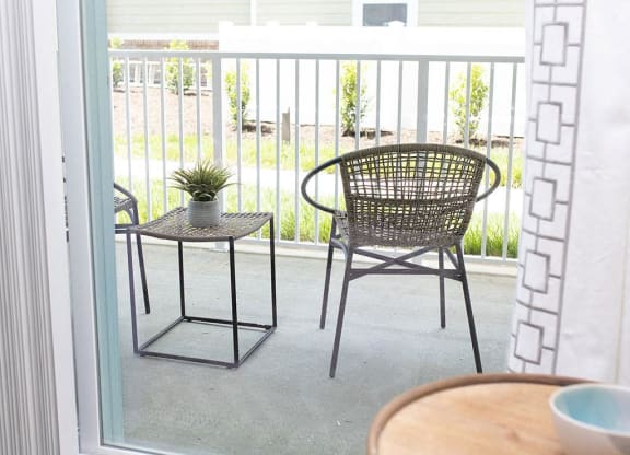 a patio with a chair and a table  at Sapphire at Centerpointe, Virginia