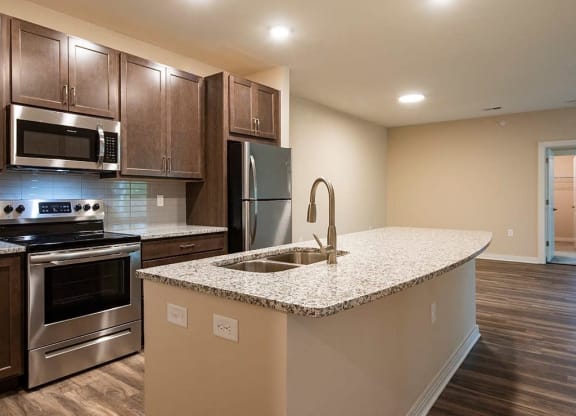 a kitchen with a large island and stainless steel appliances  at Sapphire at Centerpointe, Midlothian, 23114