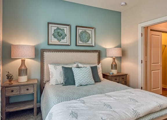 a bedroom with a bed and two night stands with lamps  at Sapphire at Centerpointe, Midlothian, Virginia