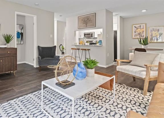 a living room filled with furniture and a flat screen tv at Trails at Short Pump Apartments, Richmond, VA, 23233