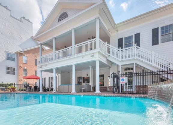 a large swimming pool in front of a white building at Sterling Manor, Williamsburg, VA 23185