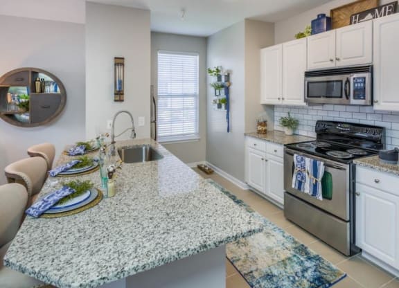 a kitchen with a counter top next to a stove top oven at Sterling Manor, Virginia