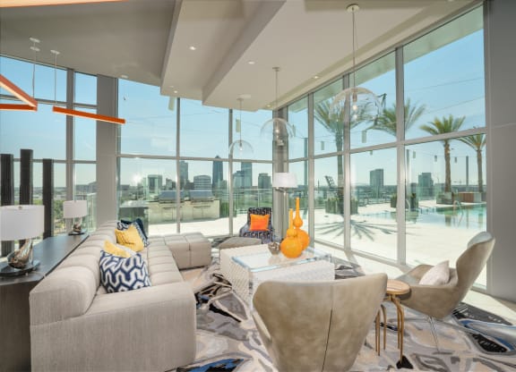 a living room with a view of the water and a couch and chairs at Vista Brooklynn Apartments, Jacksonville