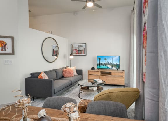 a living room with a couch and a tv at Vista Brooklynn Apartments, Jacksonville