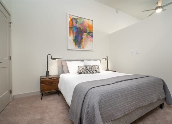 a bedroom with a bed and a painting on the wall at Vista Brooklynn Apartments, Florida