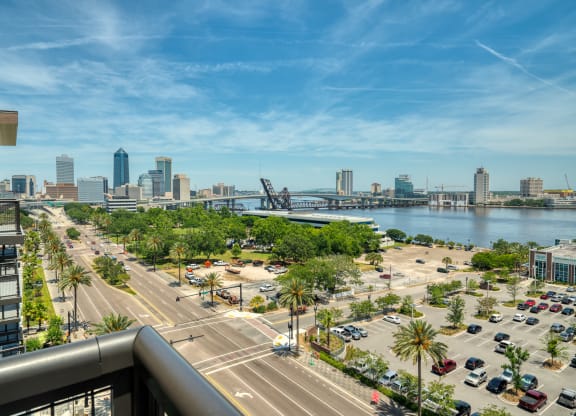 a view of a city from a balcony overlooking the water and a city skyline at Vista Brooklynn Apartments, Jacksonville, Florida