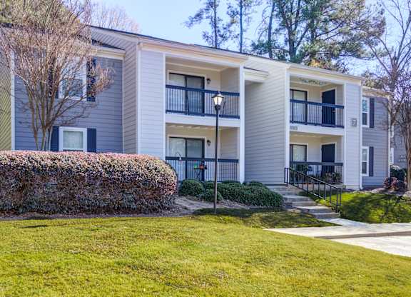 Apartment building with a green lawn in front.