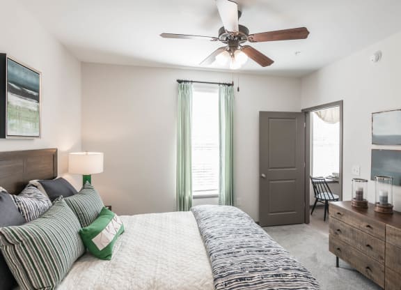 a bedroom with a bed and a ceiling fan at Village at Westland Cove Apartments, Tennessee, 37922