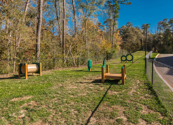 a dog park with agility equipment and a fence at Village at Westland Cove Apartments, Tennessee