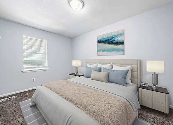 A bedroom with a large bed and a painting on the wall.