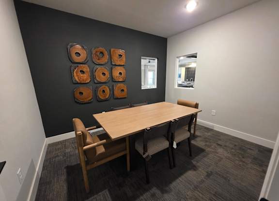 A conference room with a table and chairs.