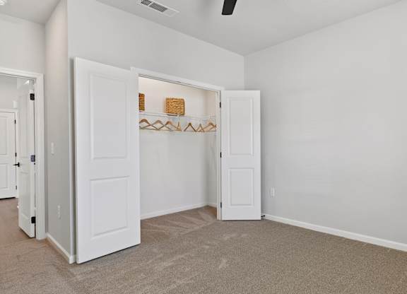 A room with a white door and a shelf with a few items on it.