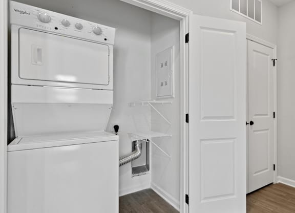 A white oven is built into a kitchen wall.