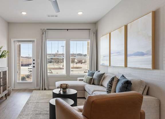 A living room with a couch, a chair, and a table.