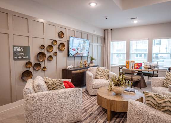 A living room with a sofa, chairs, and a coffee table.