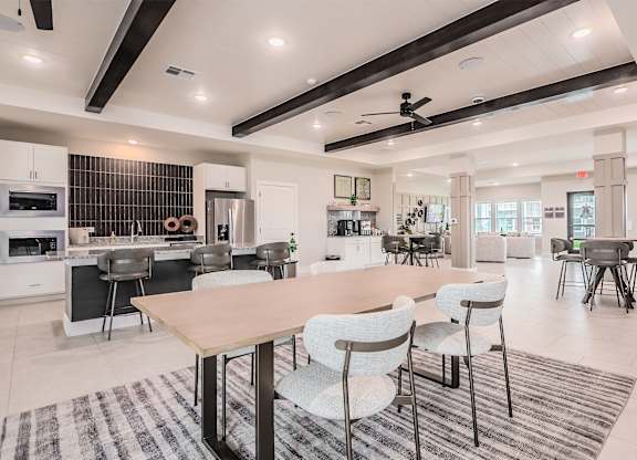 A modern kitchen with a dining table and chairs.