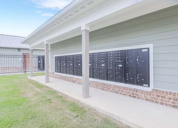 A row of mailboxes are on the side of a building.